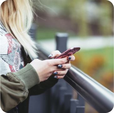 woman with black nails on mobile phone